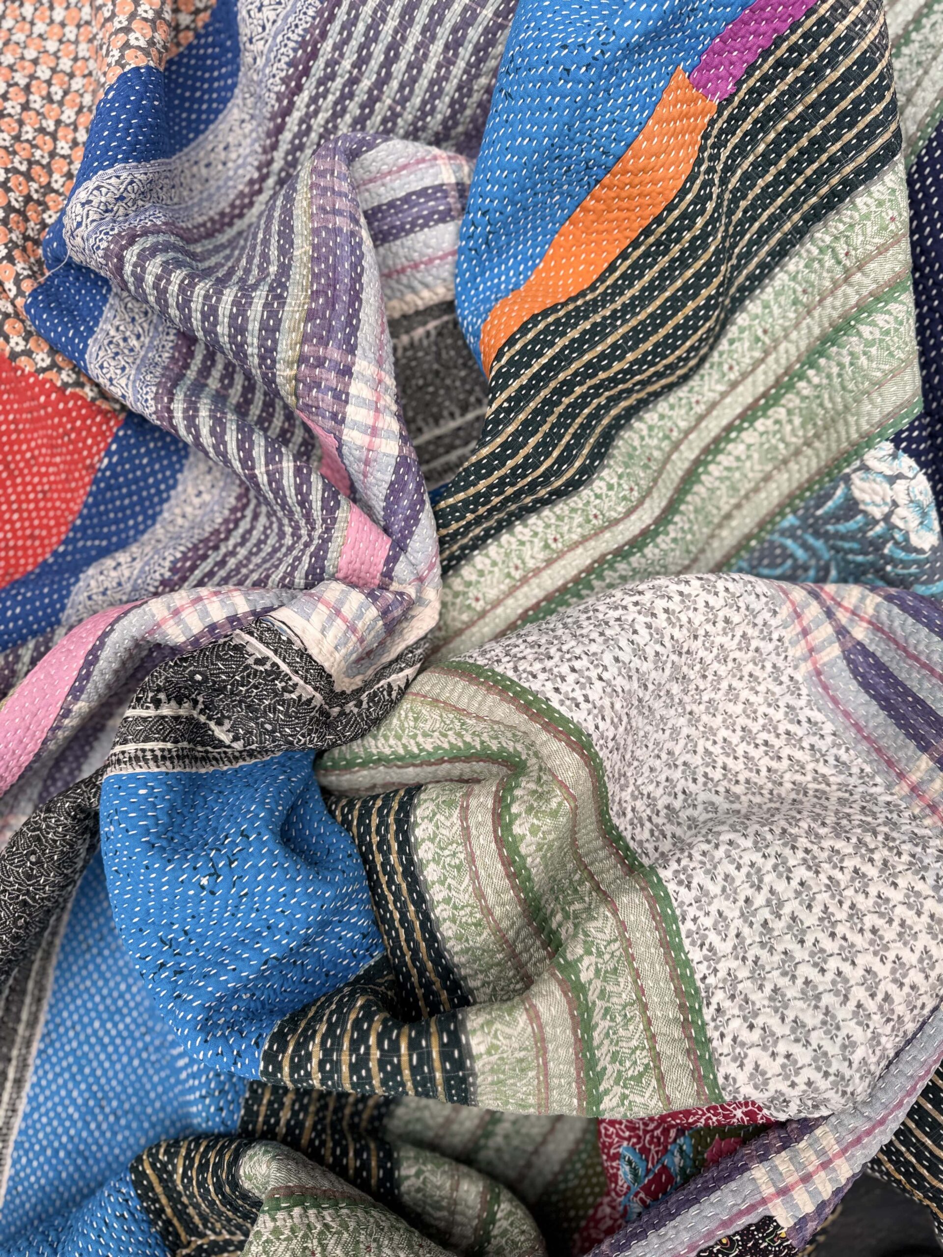 Exquisite vintage Kantha quilt featuring authentic hand-stitched Indian patchwork, responsibly sourced and perfect as unique homeware.