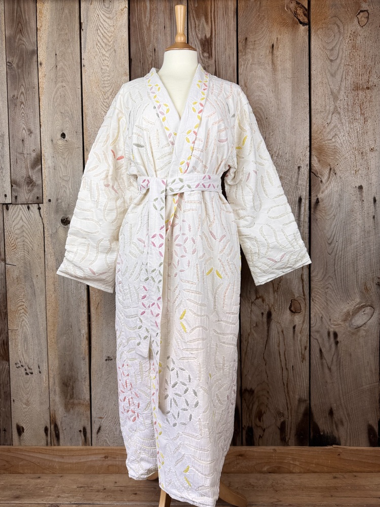 A luxury white dressing gown made using the traditional Indian technique of Cutwork. Additional hand embroidery in pastel shades.