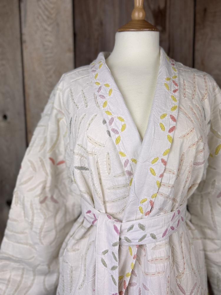A luxury white dressing gown made using the traditional Indian technique of Cutwork. Additional hand embroidery in pastel shades.