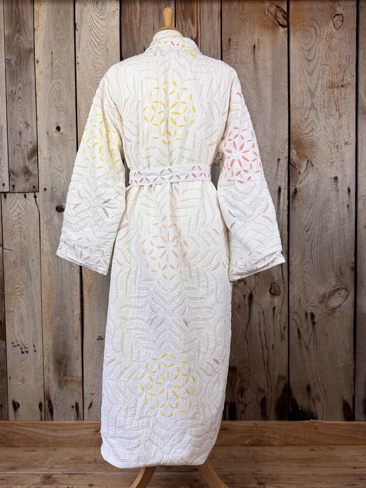 A luxury white dressing gown made using the traditional Indian technique of Cutwork. Additional hand embroidery in pastel shades.