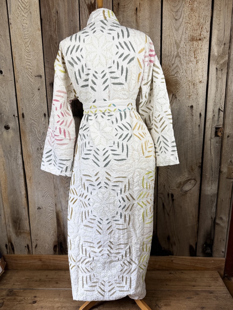 A luxury white dressing gown made using the traditional Indian technique of Cutwork. Additional hand embroidery in pastel shades.
