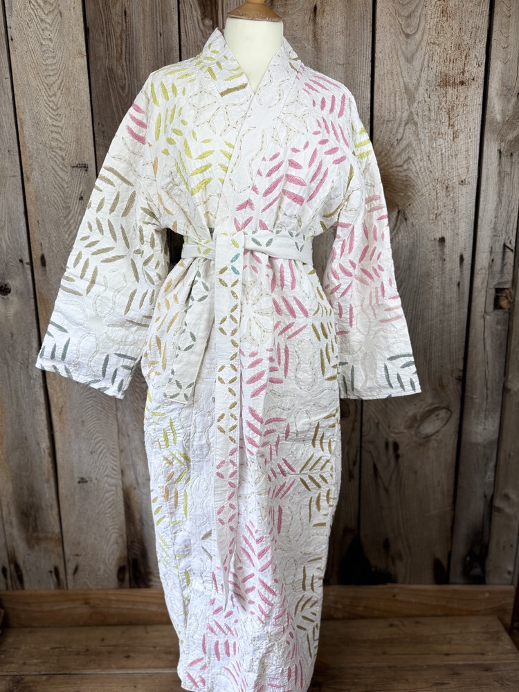 A luxury white dressing gown made using the traditional Indian technique of Cutwork. Additional hand embroidery in pastel shades.