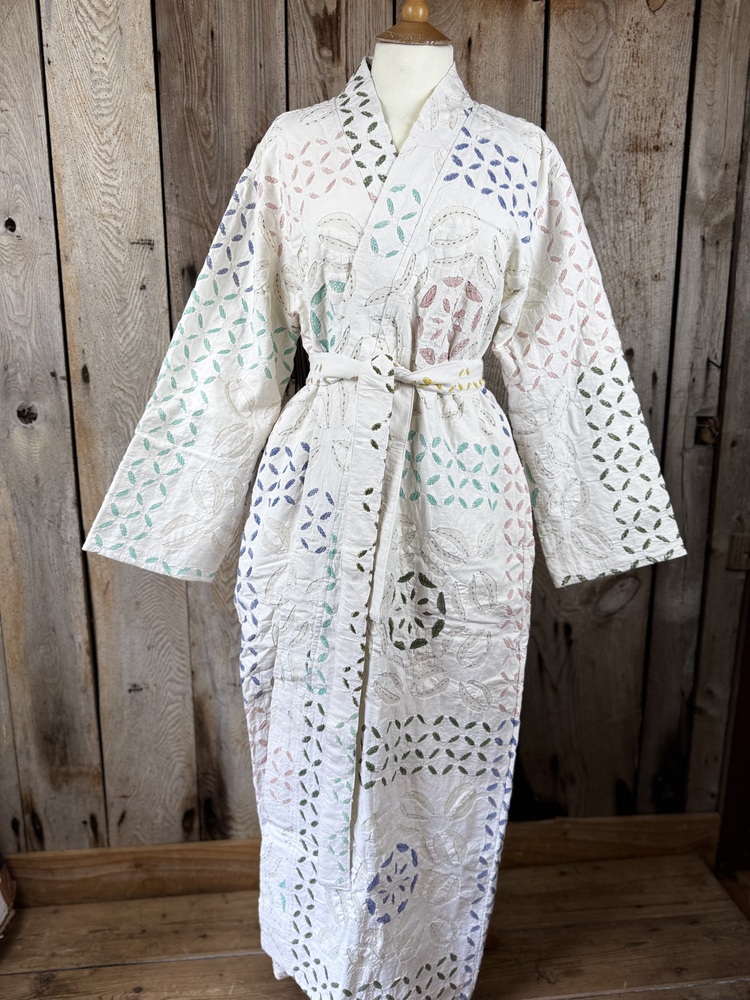 A luxury white dressing gown made using the traditional Indian technique of Cutwork. Additional hand embroidery in pastel shades.