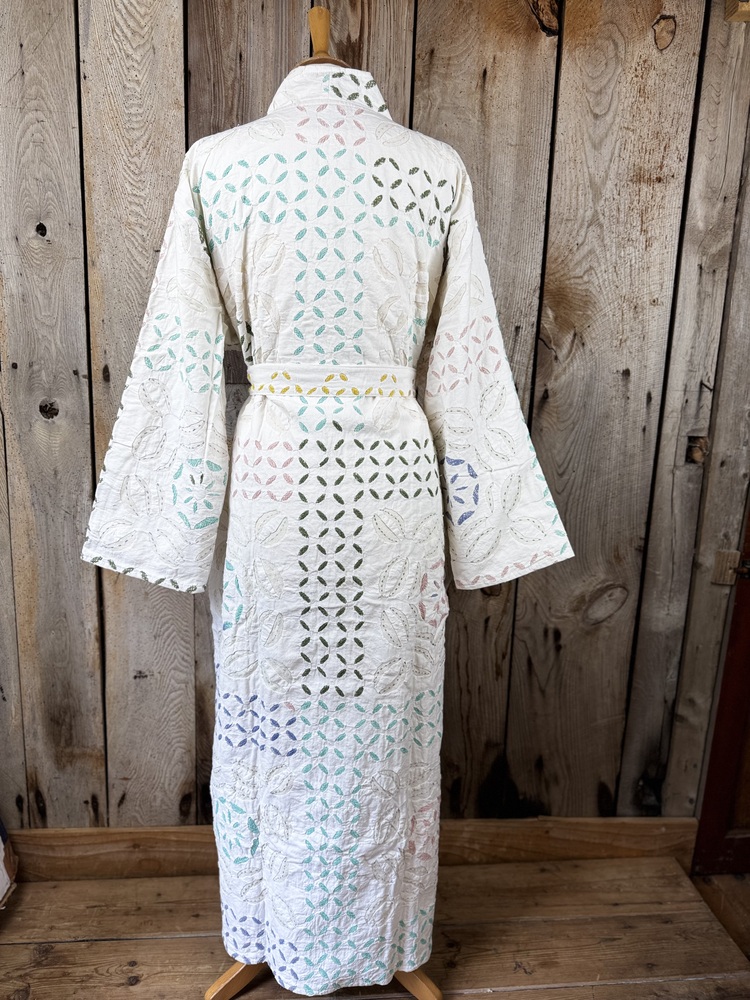 A luxury white dressing gown made using the traditional Indian technique of Cutwork. Additional hand embroidery in pastel shades.