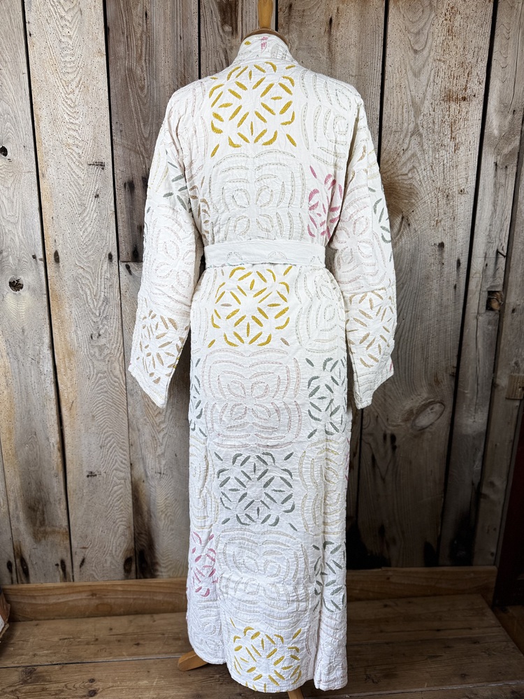 A luxury white dressing gown made using the traditional Indian technique of Cutwork. Additional hand embroidery in pastel shades.