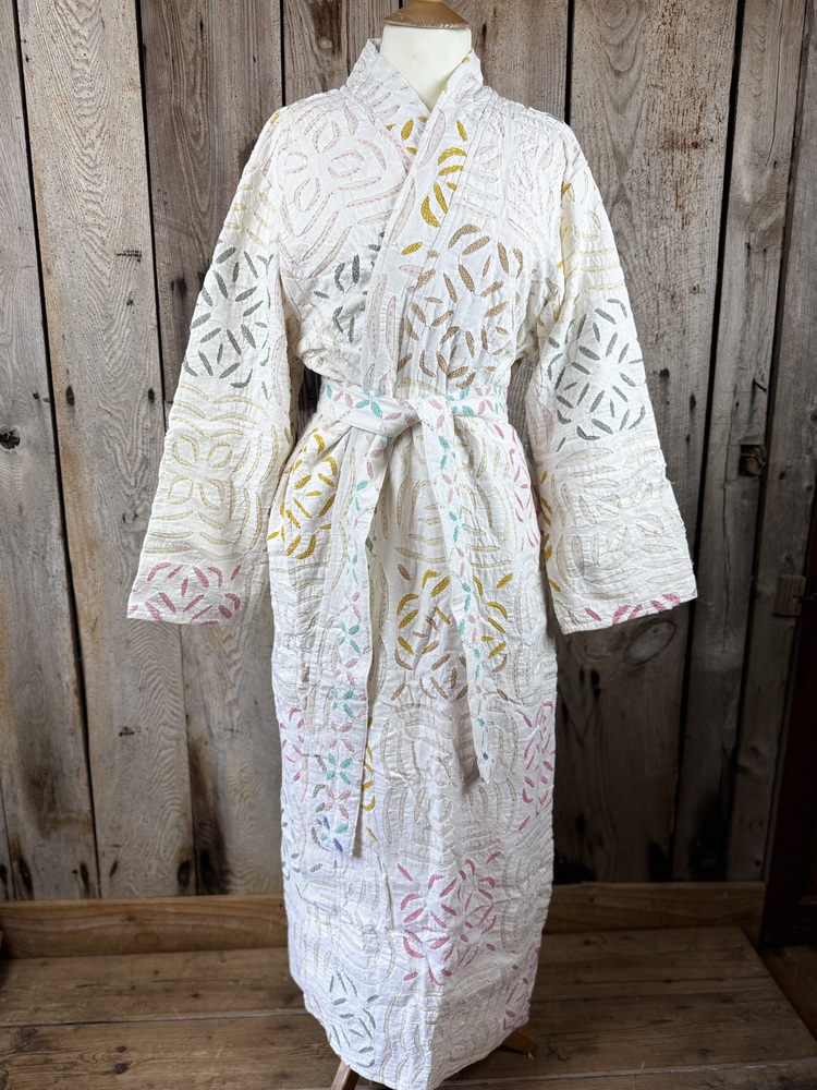 A luxury white dressing gown made using the traditional Indian technique of Cutwork. Additional hand embroidery in pastel shades.